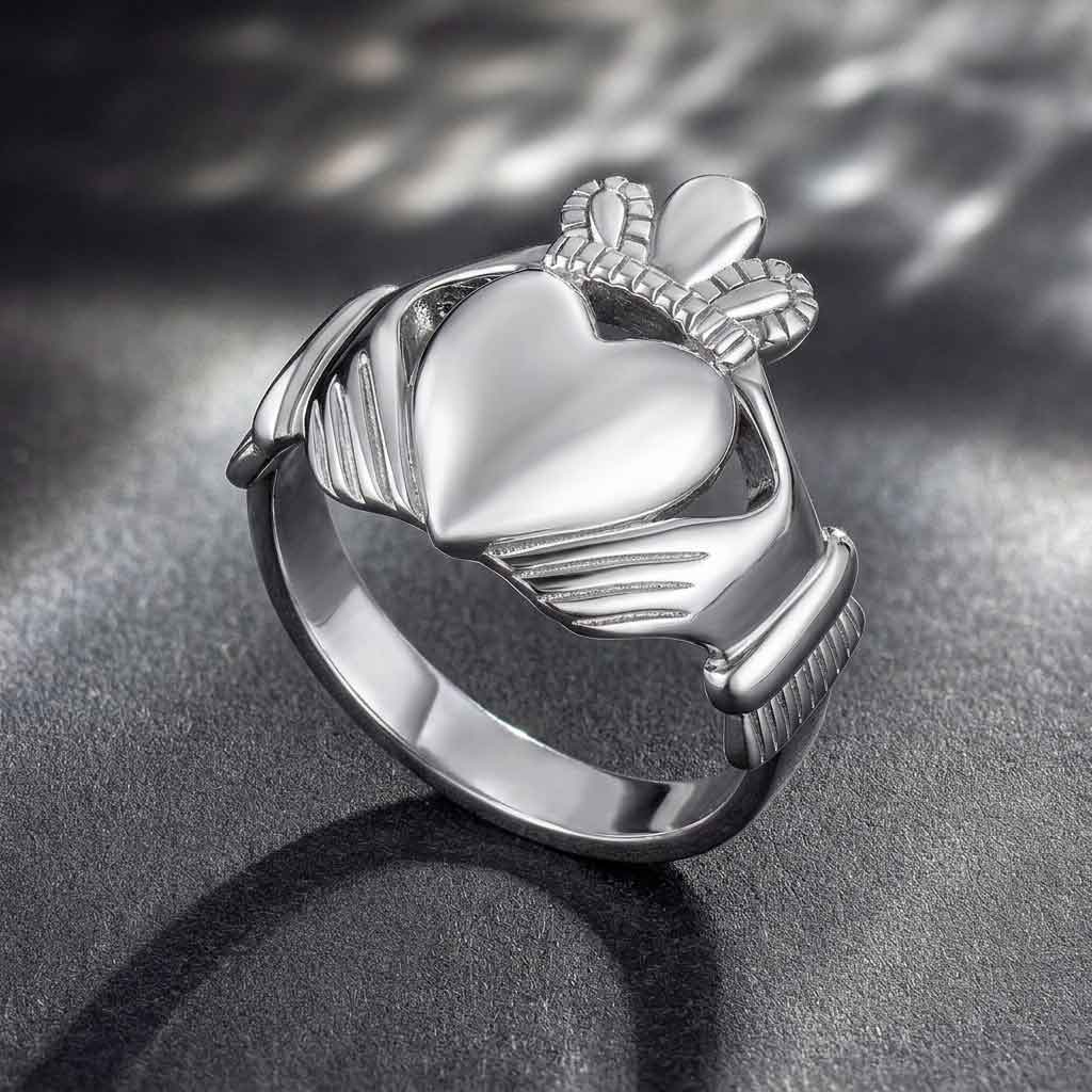 sterling silver large heart men's claddagh ring on a dark textured surface
