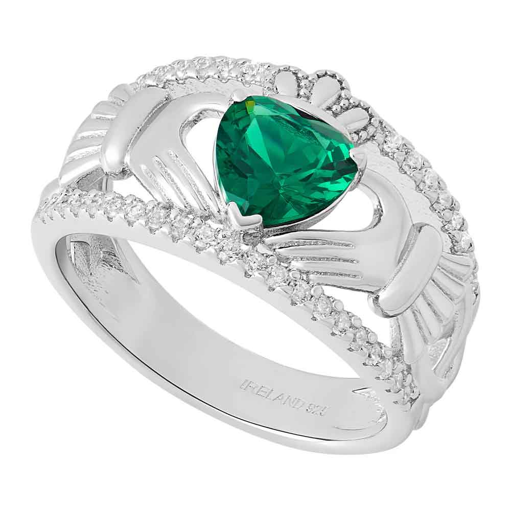 sterling silver celtic band with green crystal claddagh ring on a white background