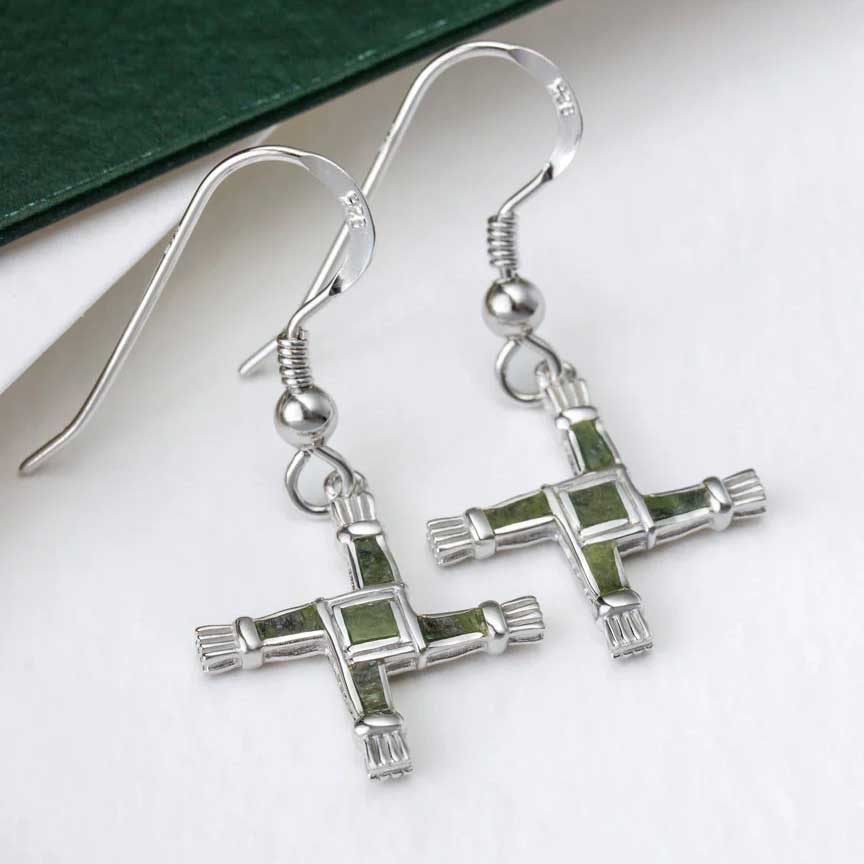 sterling silver connemara marble st. bridget's cross drop earrings  on a white surface