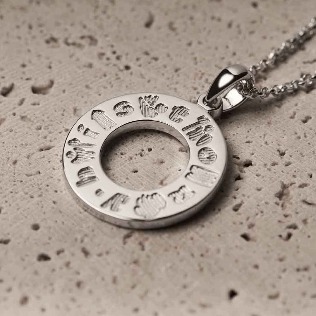 history of ireland sterling silver circle irish pendant on a textured surface