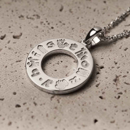 History of Ireland Sterling Silver Circle Irish Pendant on a textured surface