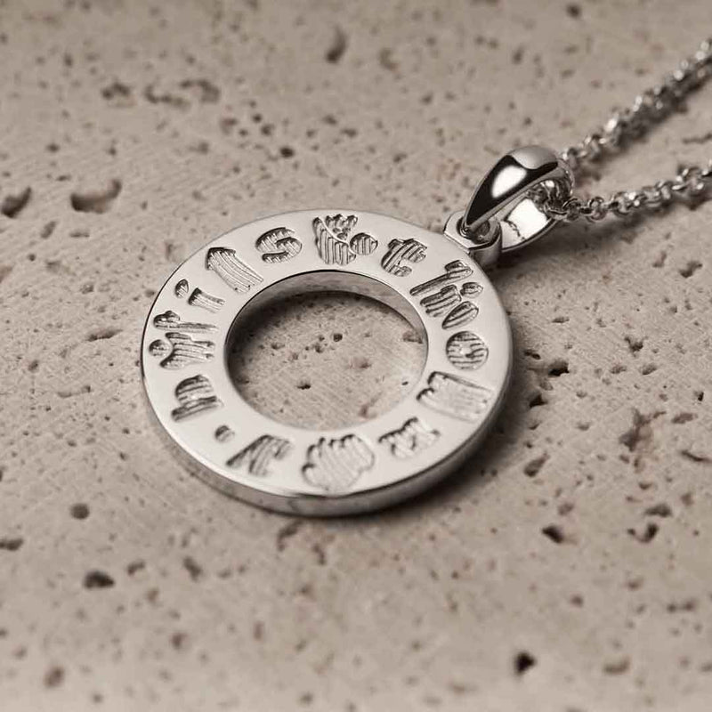 History of Ireland Sterling Silver Circle Irish Pendant on a textured surface