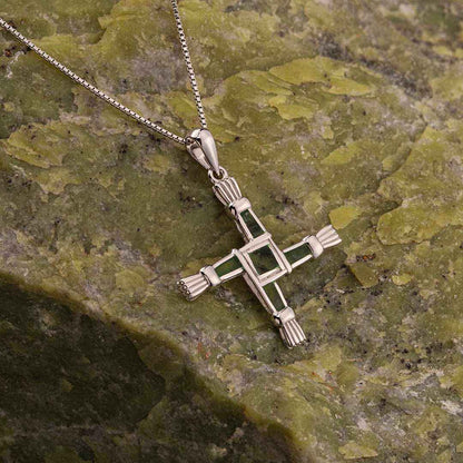 Sterling Silver Connemara Marble St. Bridget's Cross Pendant on a silver chain against a green stone background