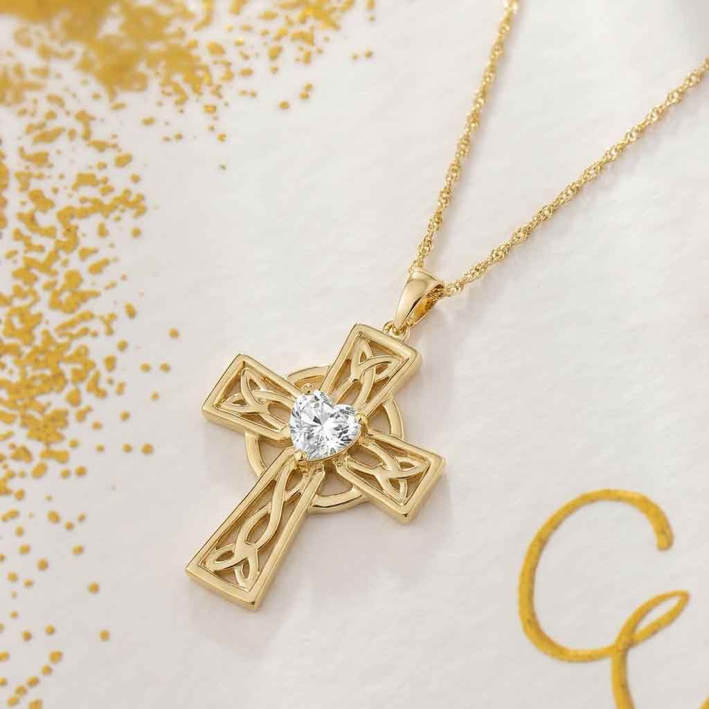14k gold celtic cross 1ct diamond heart pendant on a light background with gold confetti
