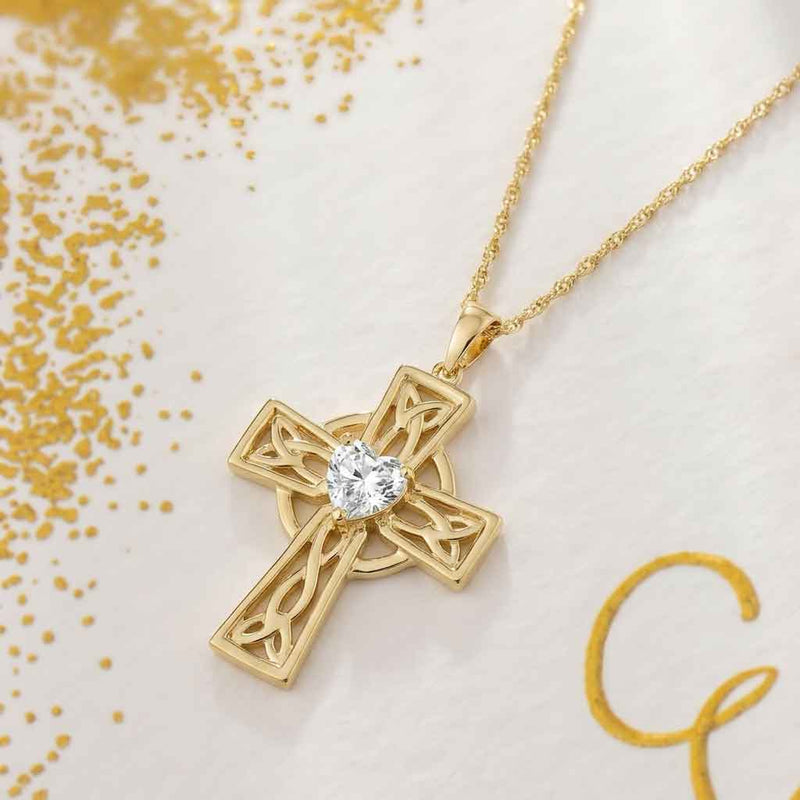 14k Gold Celtic Cross 1ct Diamond Heart Pendant on a light background with gold confetti