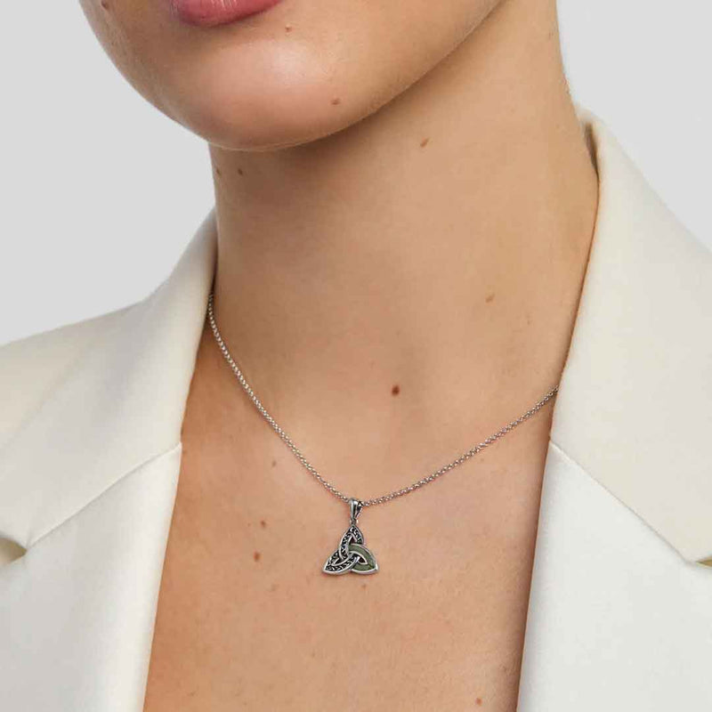 Sterling Silver Connemara Marble Accent Celtic Trinity Knot Pendant worn by a lady in a white jacket.
