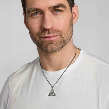 Man wearing a white shirt modelling a Sterling Silver Connemara Marble Accent Celtic Trinity Knot Pendant against a light gray background