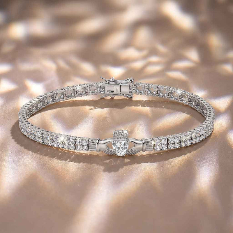 Sterling Silver Multi Set Crystal Claddagh Tennis Bracelet on a textured beige background