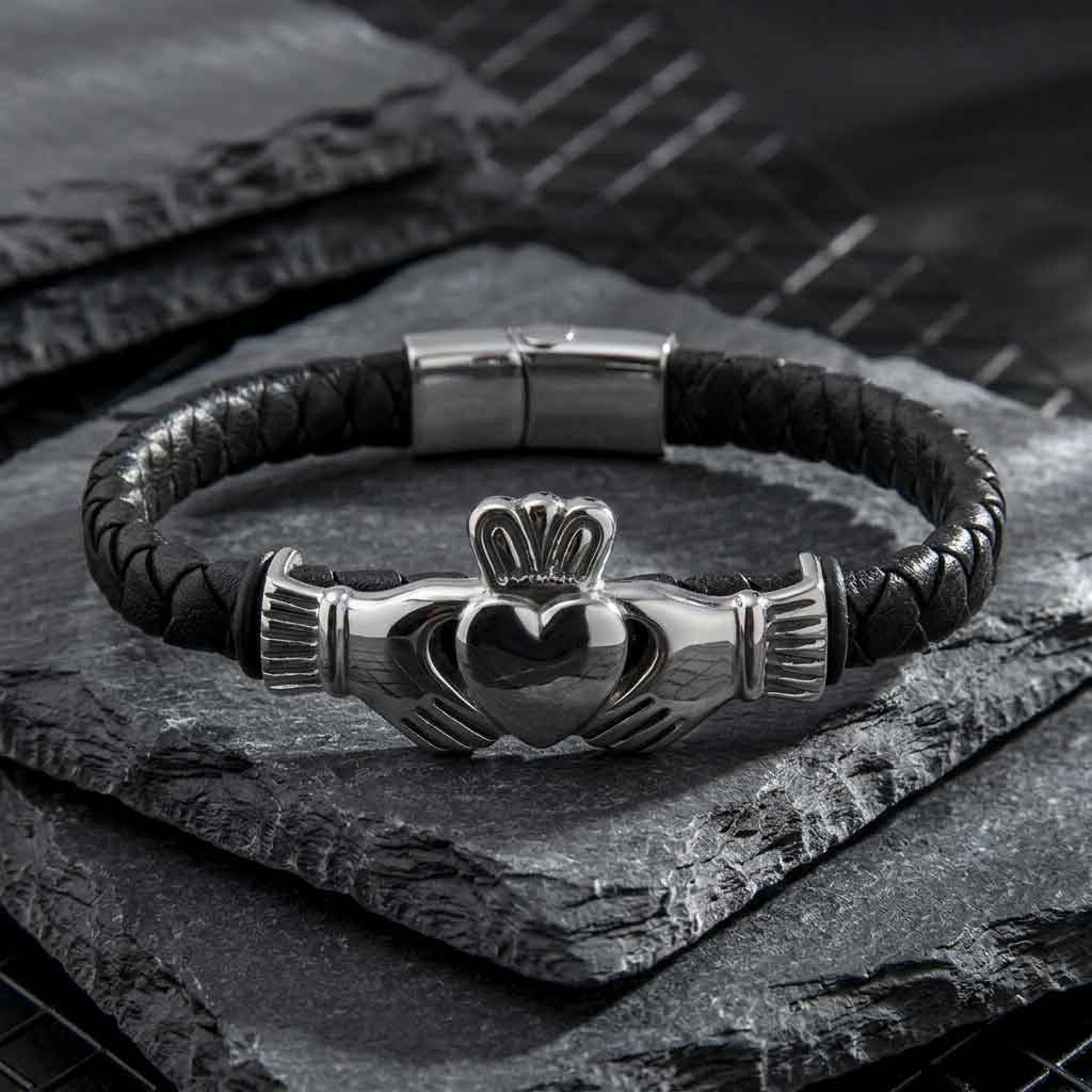 rhodium plated leather mens claddagh bracelet on a dark stone surface