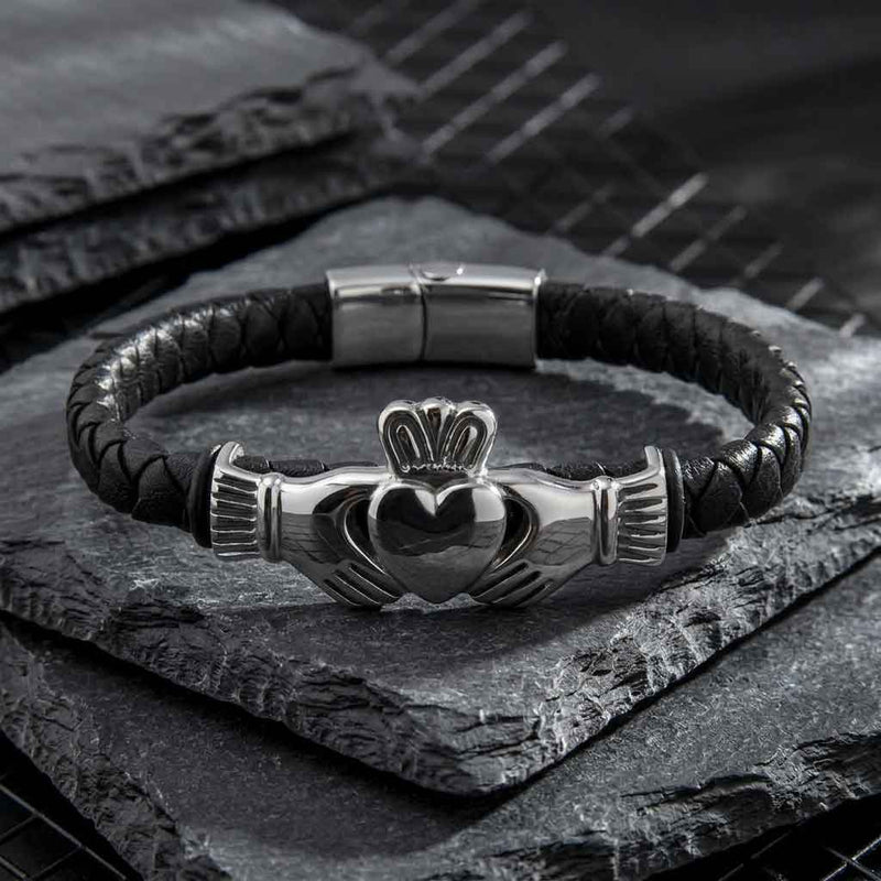 Rhodium Plated Leather Mens Claddagh Bracelet on a dark stone surface