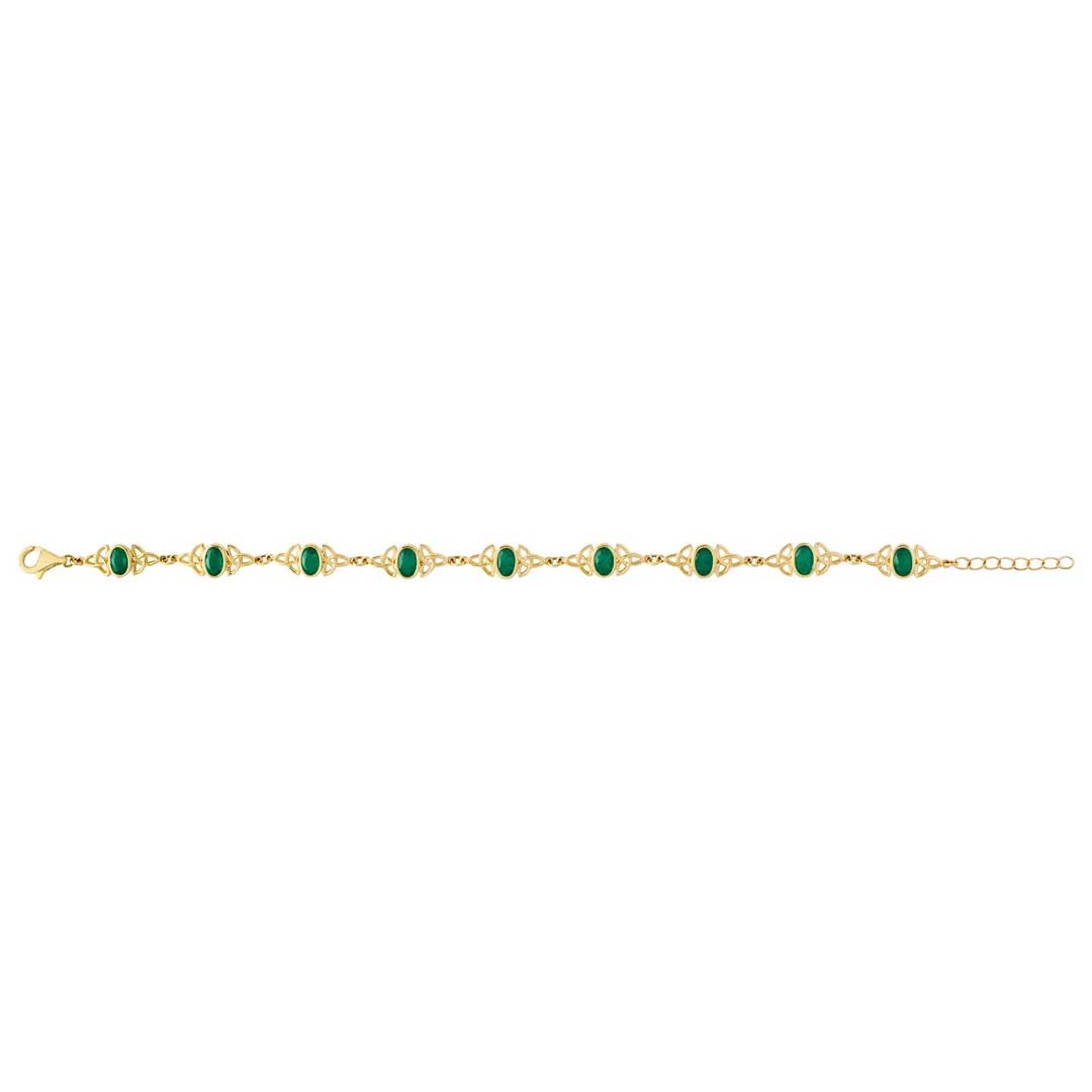 an irish 14k gold emerald trinity knot bracelet , opened, on a plain white background.