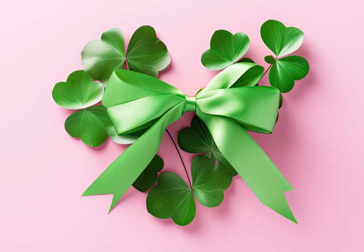 Mother's Day Banner featuring A Heart made of Shamrocks with Green bow made on a pink background