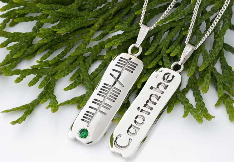 Sterling Silver necklaces with a green gemstone and the name Caoimhe engraved in Ogham text