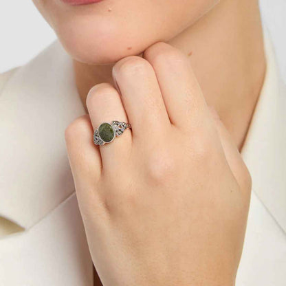 Close-up of a hand wearing a Ladies Sterling Silver Marcasite Trinity Knot Ring